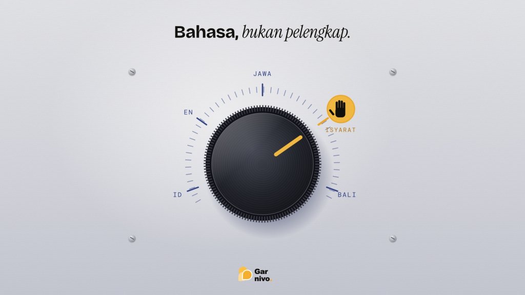 Kenop putar hitam pada panel logam terang dengan skala pilihan bahasa; penunjuk amber mengarah ke ikon tangan bertuliskan isyarat.